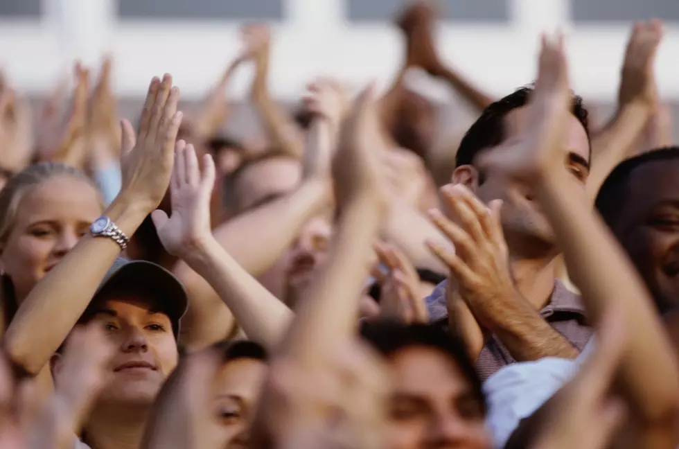 Group of spectators applauding in a stadium